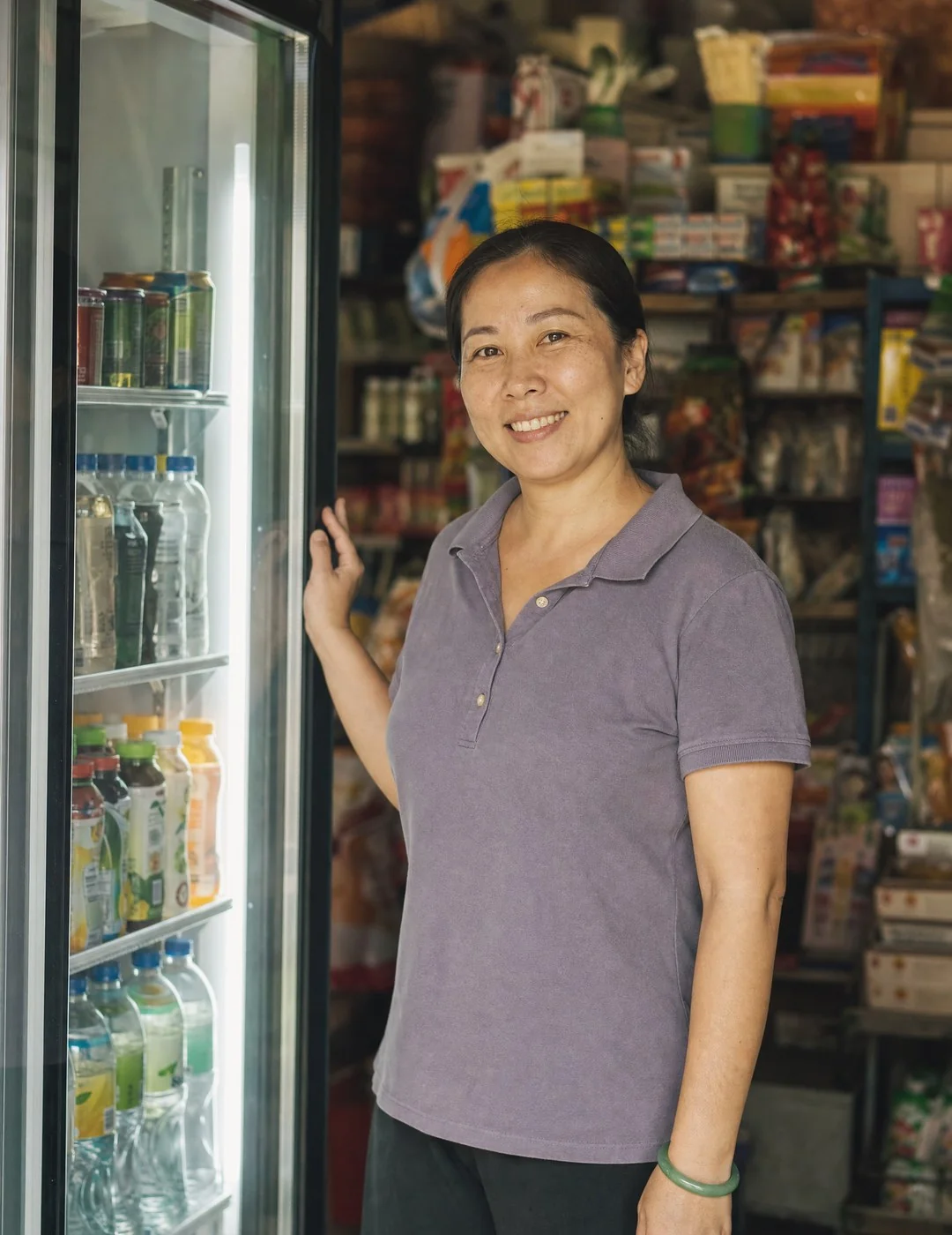 Mei Ling, a provision-shop owner in Ipoh, beside a newly financed display chiller